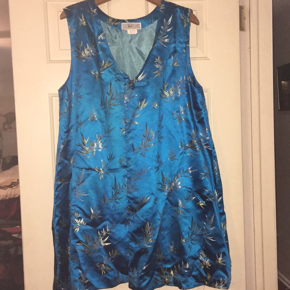 Long satin oriental vest with one button closure.